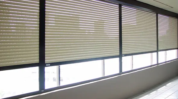 A wall of windows in a condo protected with retractable shutters.