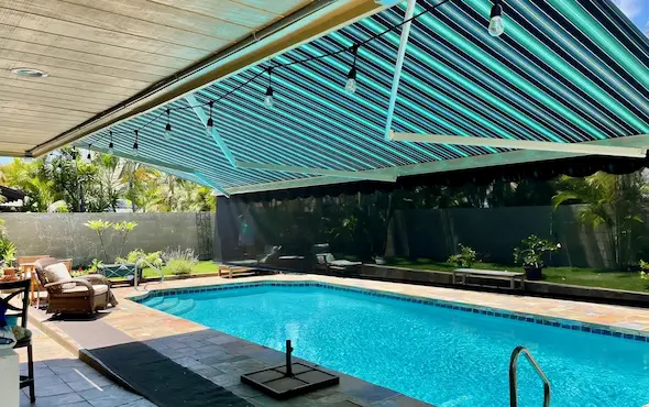 Outdoor pool shaded by a retractable awning.